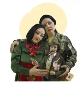 Well where to begin! This is a triptych of figures in the style of a Holy family. One figure is Birdie Allslop. Then Bird is dressed as a carpenter in a plaid shirt with a mallet in pocket. In the middle is an mini Birdie dressed as a posh farmer in a tweed hat and wax jacket. She is holding a cardboard cutout of a border collie. She is making a pointed gesture like a medieval painting.