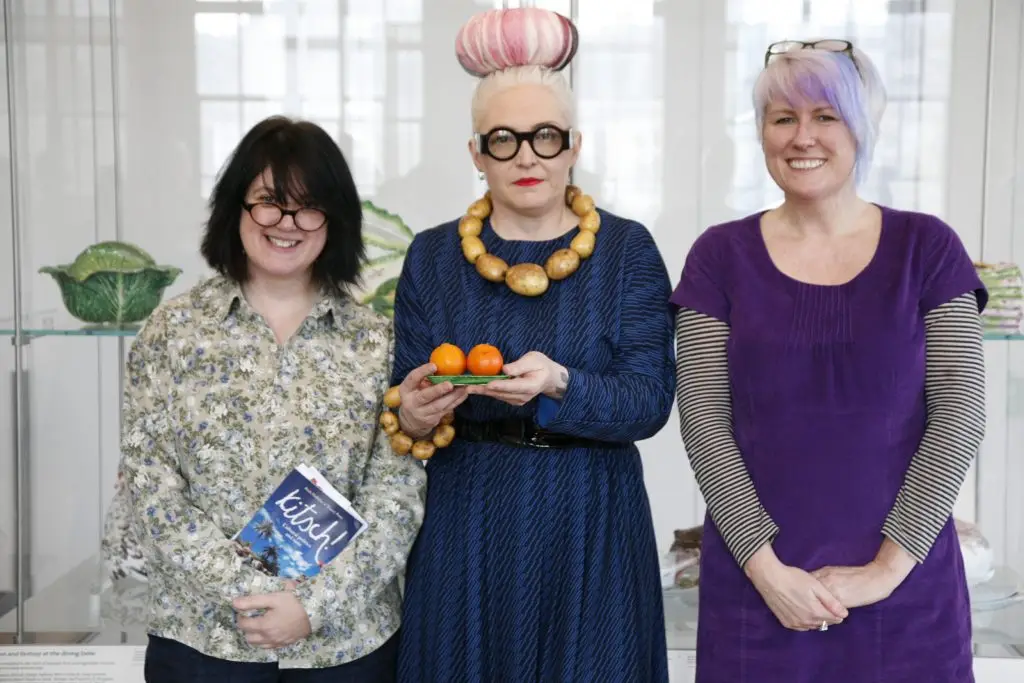 Photo portrait of Tracey holding her book Kitsch, Birdie holding two satsumas and Ruth not holding anything!